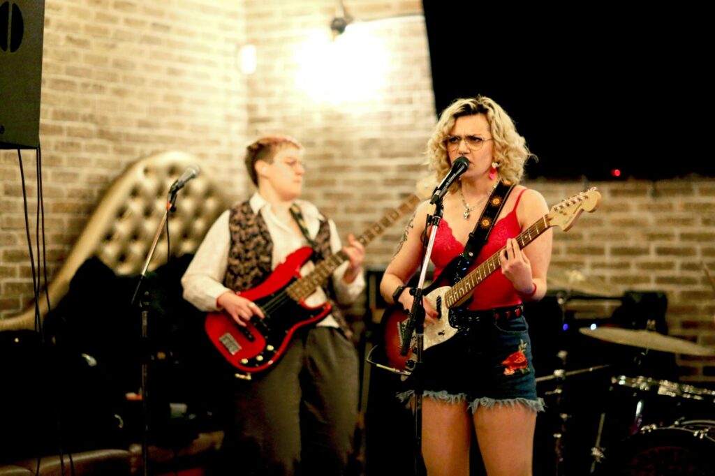 Photo of two performers playing guitar and singing on-stage at a venue during February 2025's Long Weekend Band Crawl in Waterloo, Ontario.