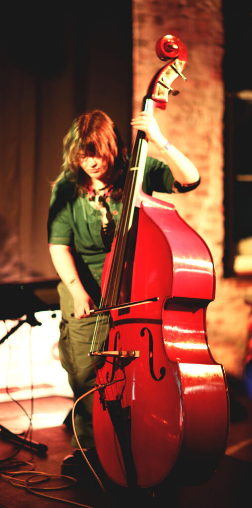 Photo of someone passionately playing a double bass on stage during February 2025's Long Weekend Band Crawl in Waterloo, Ontario.