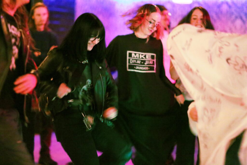 Photo of people furiously dancing with a ghost during February 2025's Long Weekend Band Crawl in Waterloo, Ontario.