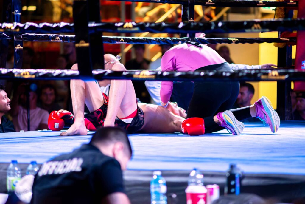 Photo taken inside the Galt Arena Gardens during the Fight Night 2 event of a fighter collapsed inside the ring while a referee checks their condition.